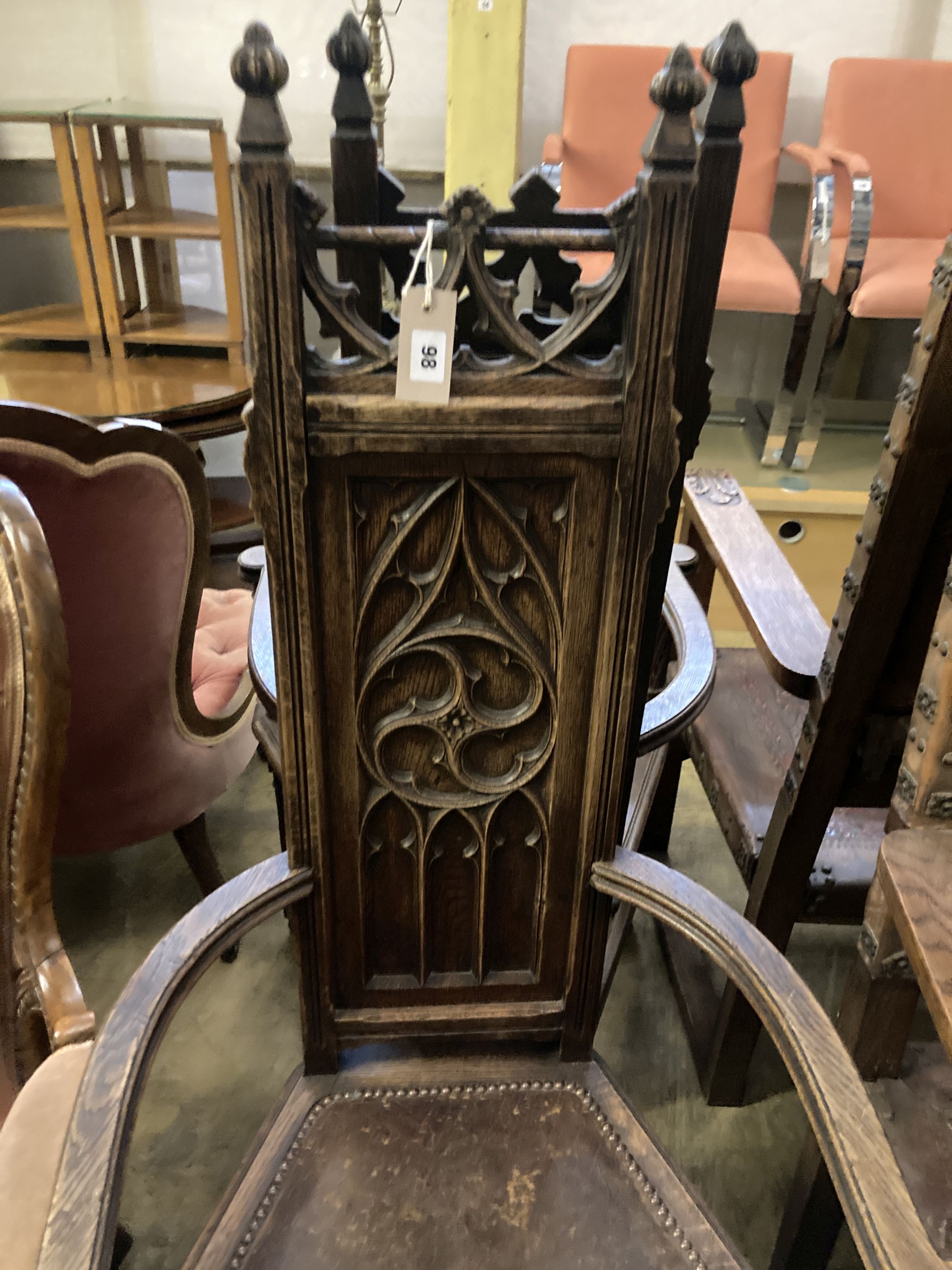 A pair of Gothic-style oak elbow chairs, width 59cm, depth 43cm, height 127cm